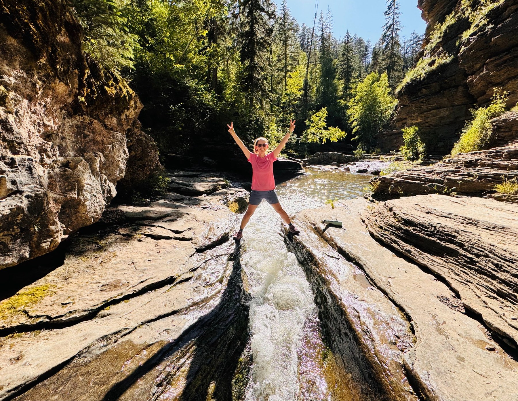 Gabrielle hiking beside a mountain stream